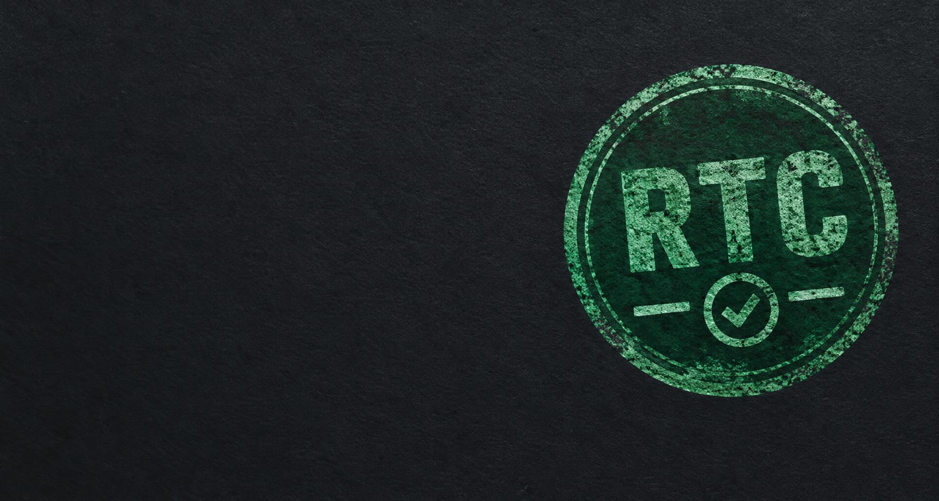 RTC certification stamp pressed into dark charcoal paper